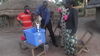 Francise can now get clean water for the family members and is pumping while the family testing the clean water